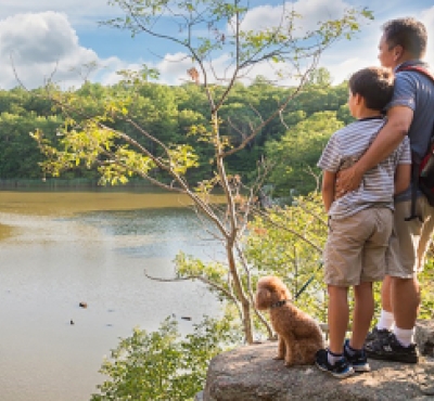 Man and son with their dog at peak on hike in Guilford