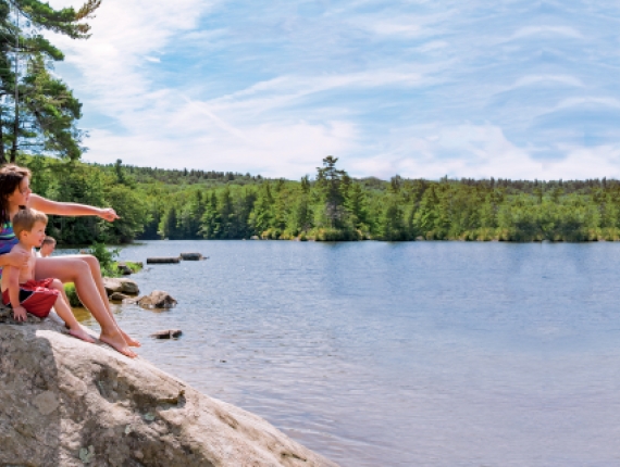 Two kids on rocks overlooking Burr Pond